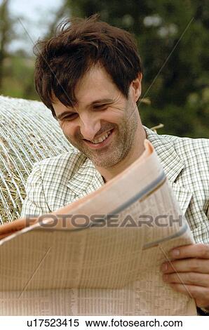 Man reading newspaper outdoors View Large Photo Image Stock Photography - Man reading newspaper outdoors. Fotosearch
