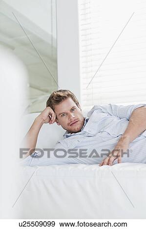 Stock Photo - Man relaxing on couch. Fotosearch