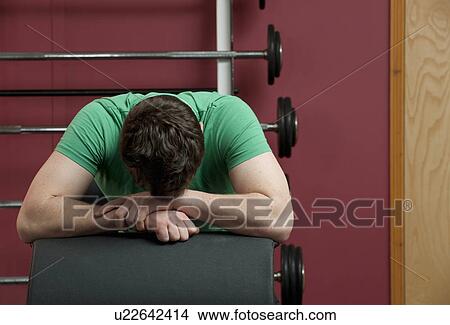 Man resting in gym View Large Photo Image Picture - Man resting in gym. Fotosearch