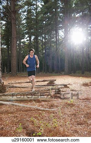 Man running in forest View Large Photo Image Stock Image - Man running in forest. Fotosearch
