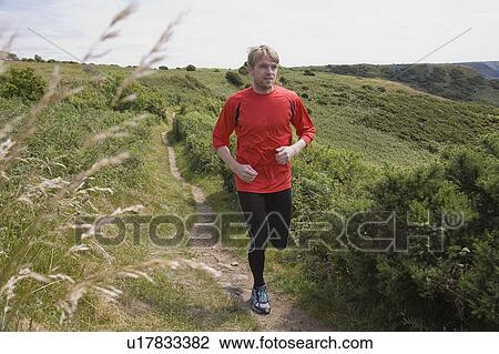 Man running on rural path View Large Photo Image Stock Image - Man running on rural path. Fotosearch
