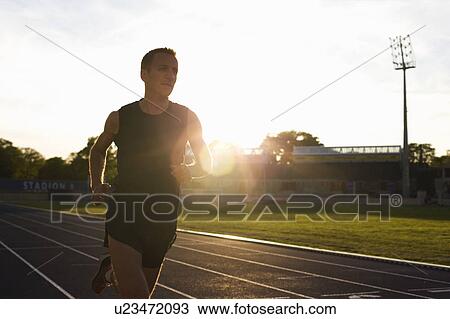Stock Image - Man running on track. Fotosearch