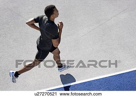 Stock Image - Man running on track. Fotosearch