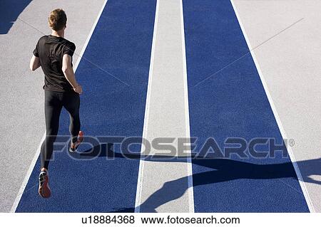 Stock Photo - Man running on track. Fotosearch