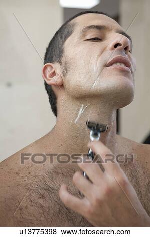 Stock Photo - Man shaving in bathroom. Fotosearch
