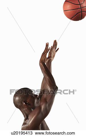 Man shooting basketball into hoop View Large Photo Image Stock Image - Man shooting basketball into hoop. Fotosearch