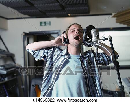 Man singing in recording studio View Large Photo Image Stock Image - Man singing in recording studio. Fotosearch