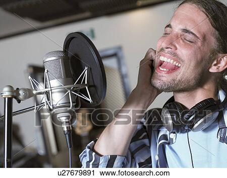 Man singing in recording studio View Large Photo Image Stock Image - Man singing in recording studio. Fotosearch