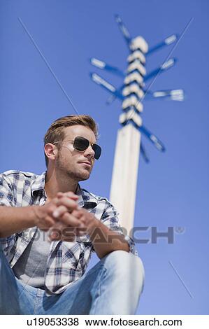 Stock Photo - Man sitting at crossroads. Fotosearch