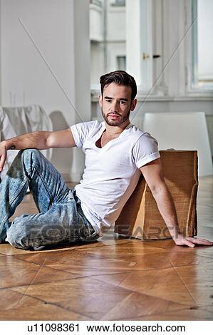 Man sitting on floor View Large Photo Image Stock Image - Man sitting on floor. Fotosearch