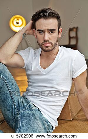 Stock Photograph - Man sitting on floor. Fotosearch