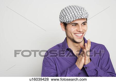 Stock Photo - Man smiling and rubbing his hands. Fotosearch