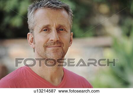 Man smiling in backyard View Large Photo Image Stock Photo - Man smiling in backyard. Fotosearch