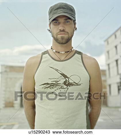 Man standing in courtyard View Large Photo Image Stock Image - Man standing in courtyard. Fotosearch