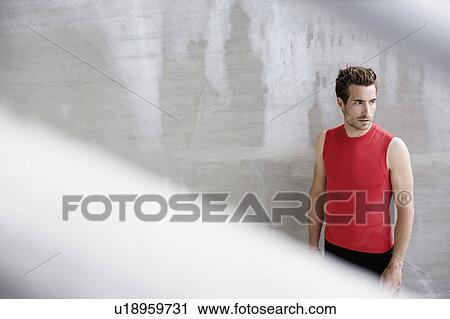 Man standing near wall View Large Photo Image Stock Image - Man standing near wall. Fotosearch