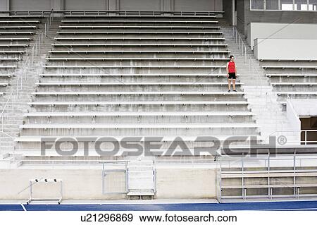 Stock Photo - Man standing on stadium steps. Fotosearch