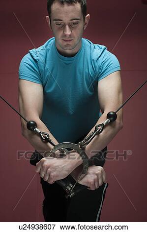 Man using exercise machine in gym View Large Photo Image Stock Photo - Man using exercise machine in gym. Fotosearch
