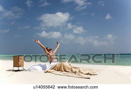 Man waking up in bed on beach View Large Photo Image Stock Image - Man waking up in bed on beach. Fotosearch