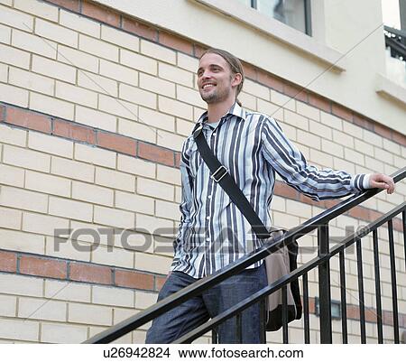 Man walking down steps outdoors View Large Photo Image Picture - Man walking down steps outdoors. Fotosearch