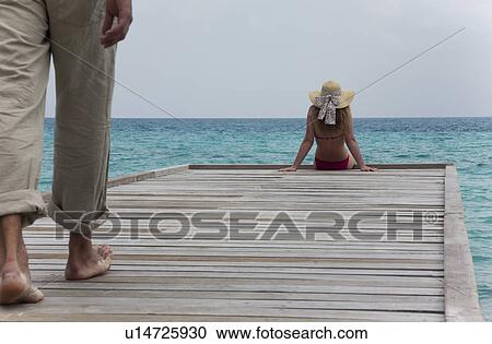Man walking towards woman on deck View Large Photo Image Stock Image - Man walking towards woman on deck. Fotosearch