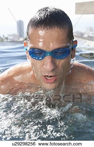 Man wearing goggles in swimming pool View Large Photo Image Stock Photograph - Man wearing goggles in swimming pool. Fotosearch