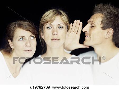 Man whispering into woman’s ear View Large Photo Image Stock Photo - Man whispering into woman’s ear. Fotosearch