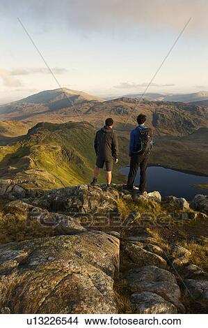 Men admiring mountain view View Large Photo Image Picture - Men admiring mountain view. Fotosearch