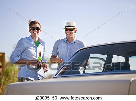 Men drinking beer and smoking by car View Large Photo Image Stock Image - Men drinking beer and smoking by car. Fotosearch