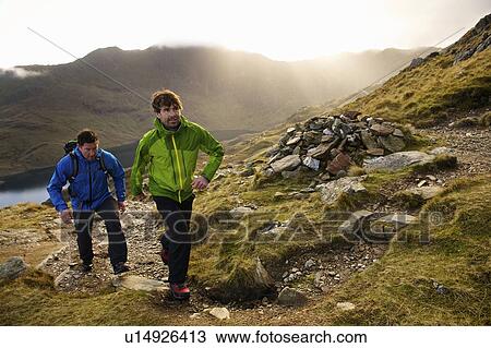 Men hiking on rocky mountainside View Large Photo Image Stock Image - Men hiking on rocky mountainside. Fotosearch