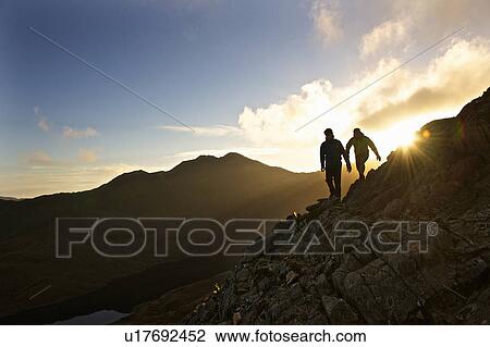 Men hiking on rocky mountainside View Large Photo Image Stock Image - Men hiking on rocky mountainside. Fotosearch