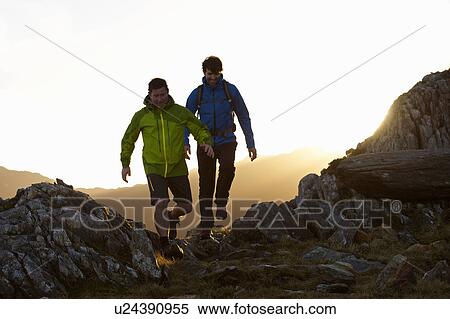 Men hiking on rocky mountainside View Large Photo Image Stock Photography - Men hiking on rocky mountainside. Fotosearch
