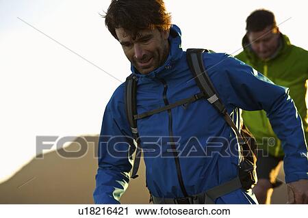 Stock Image - Men hiking together. Fotosearch