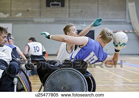Stock Photography - Men in wheelchairs playing pararugby. Fotosearch