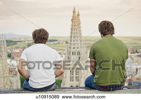 Men on wall overlooking urban cityscape View Large Photo Image Stock Photo - Men on wall overlooking urban cityscape. Fotosearch