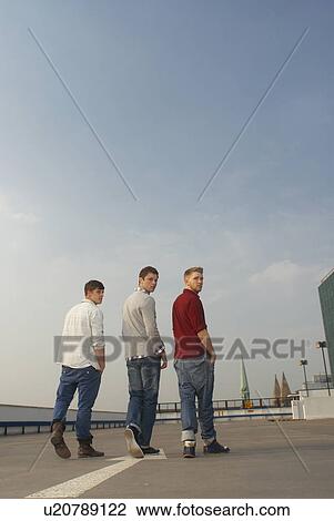 Men walking together on rooftop View Large Photo Image Stock Image - Men walking together on rooftop. Fotosearch