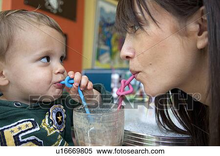 Mother and baby son using curly straws View Large Photo Image Stock Photography - Mother and baby son using curly straws. Fotosearch