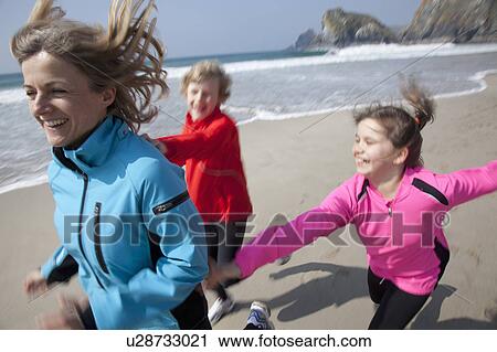 Mother and children playing on beach View Large Photo Image Stock Image - Mother and children playing on beach. Fotosearch