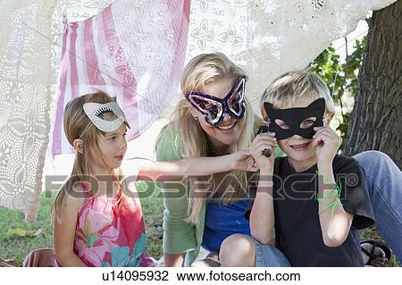 Mother and children wearing masks View Large Photo Image Stock Image - Mother and children wearing masks. Fotosearch
