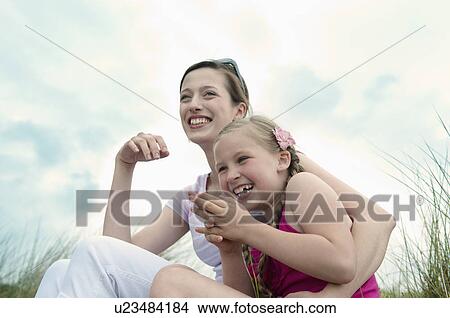 Mother and daughter hugging on beach View Large Photo Image Picture - Mother and daughter hugging on beach. Fotosearch