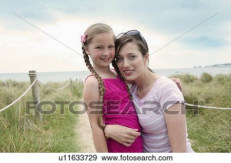 Mother and daughter hugging on beach View Large Photo Image Stock Photo - Mother and daughter hugging on beach. Fotosearch