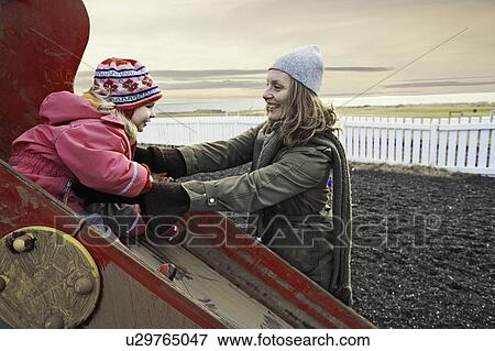Stock Photo - Mother and daughter on playground. Fotosearch