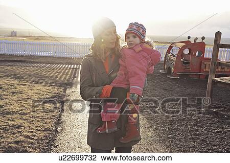 Stock Image - Mother and daughter playing outdoors. Fotosearch