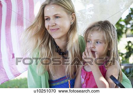 Mother and daughter sitting together View Large Photo Image Stock Image - Mother and daughter sitting together. Fotosearch