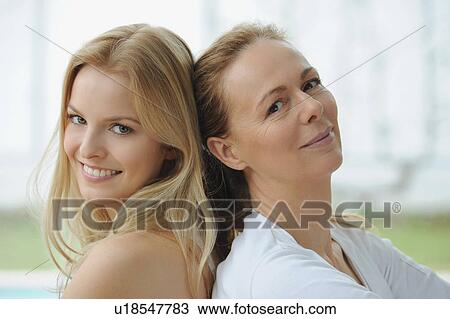 Stock Image - Mother and daughter sitting together. Fotosearch
