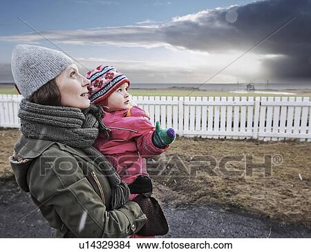 Mother and daughter watching sky View Large Photo Image Picture - Mother and daughter watching sky. Fotosearch