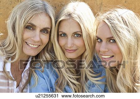 Stock Image - Mother and daughters sitting together. Fotosearch