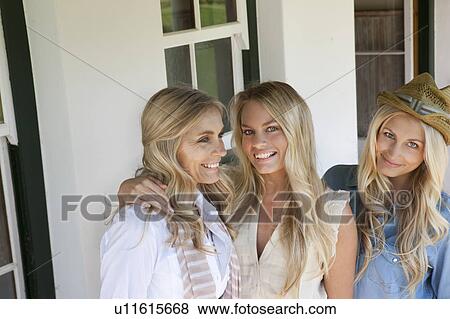 Mother and daughters standing on porch View Large Photo Image Stock Photo - Mother and daughters standing on porch. Fotosearch