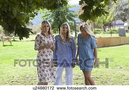 Mother and daughters standing together View Large Photo Image Stock Image - Mother and daughters standing together. Fotosearch