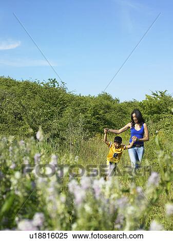 Mother and son in field of flowers View Large Photo Image Stock Photography - Mother and son in field of flowers. Fotosearch