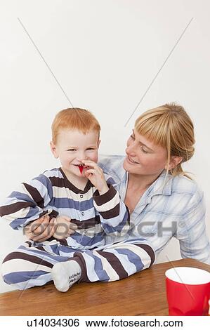 Mother and son in pajamas at table View Large Photo Image Stock Photograph - Mother and son in pajamas at table. Fotosearch
